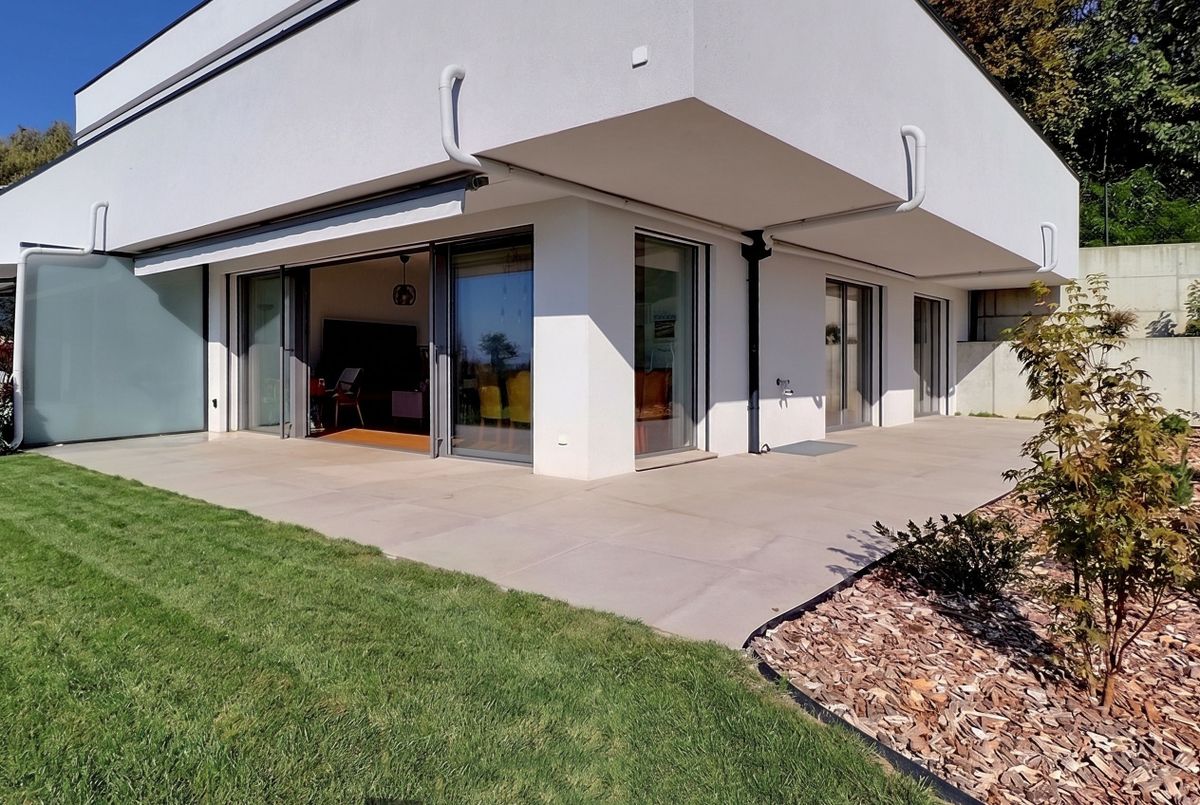 Magnifique opportunité! Appartement récent avec deux chambres, terrasse et jardin, vue panoramique sur le lac et les Alpes, une place de parc extérieure.